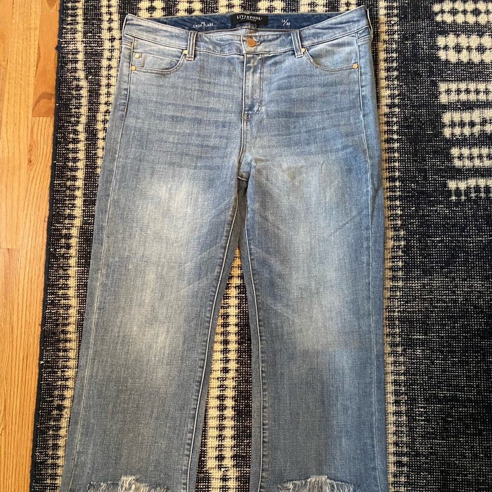 Ankle flare crop jeans with fringed hem